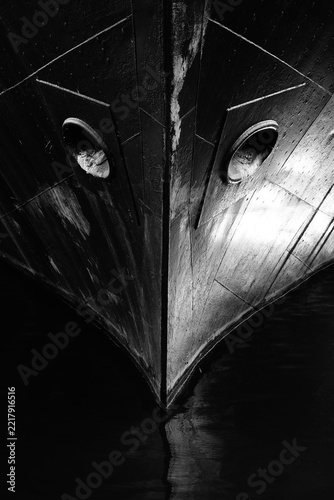 Black-and-white image of the bow of an old ship, frontal view