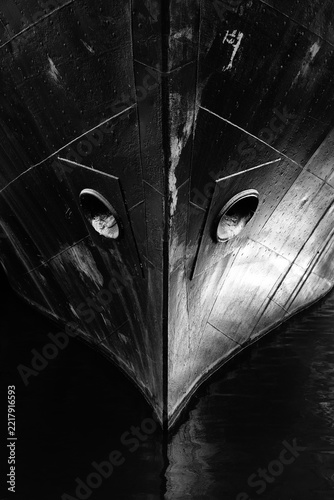 Black-and-white image of the bow of an old ship, frontal view