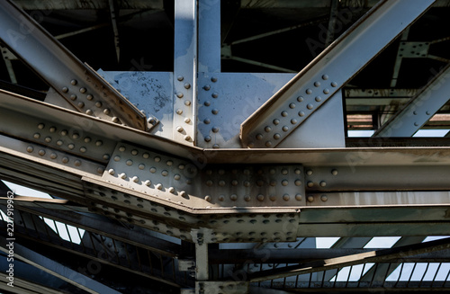 Riveted steel girder joint of industrial railway bridge.