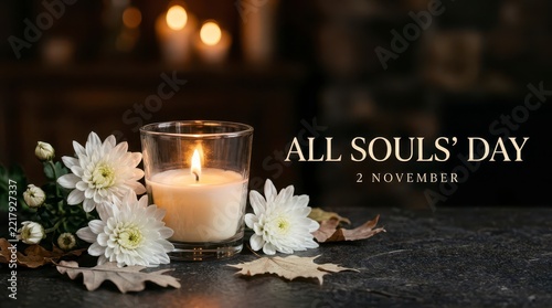 Candle lit for All Souls Day with autumn flowers