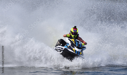 Jet Ski racer cornering at speed making lots of spray