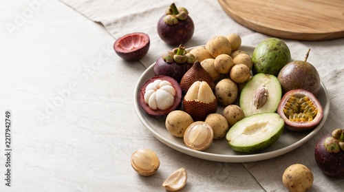 Assortment of Fresh Tropical Fruits with Mangosteen, Salak, Langsat, and Passion Fruit on a Ceramic Plate