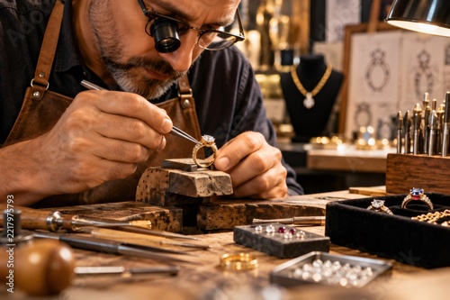 Jeweler crafting diamond ring with precision in workshop