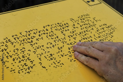 a blind person reads Braille with their hand.