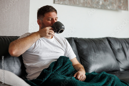 Man drinking coffee while relaxing at home