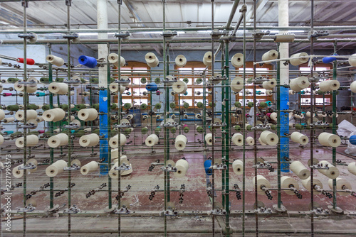 This warping machine guides yarn from many bobbins.