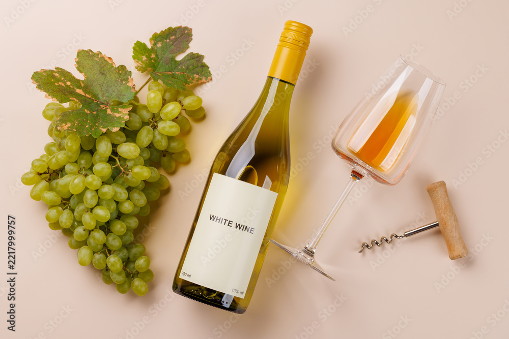 Fototapeta premium Wine glass bottle and green grapes - elegant flat lay