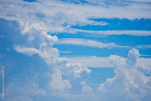 Billowing cloud shapes and blue sky on sunny day at high altitude