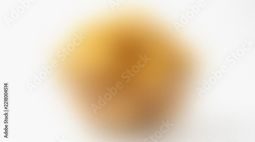 Blurred golden yellow shape against a white background presents an indistinct soft focus abstract form amorphous blurry colorfield diffusion formless goldenrod gradient