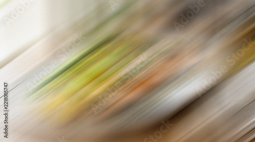 Obraz na plátně Abstract streaks of color create a blurred dynamic composition with shades of ye