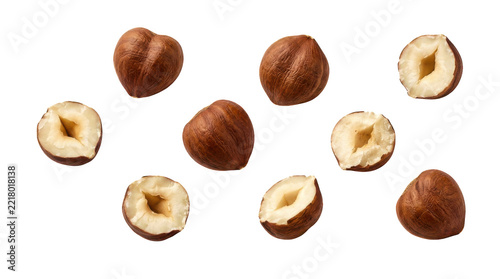 Fotografie Fresh whole and halved hazelnuts arranged on a flat surface