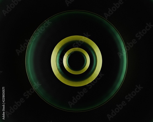 Minimalist abstract background with glowing gold concentric circles on a dark green textured surface