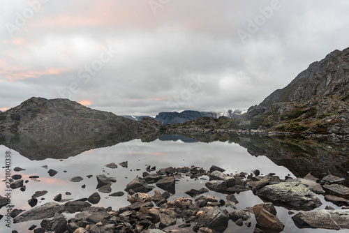 Mountain lake reflection at dawn in Daocheng Yading