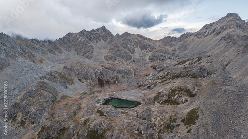 Alpine lake nestled in rugged mountain cirque, Sichuan