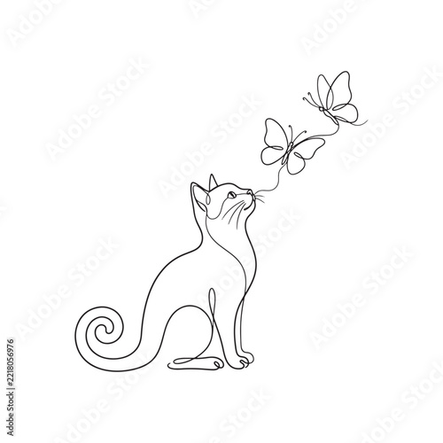 Cute cat sitting and watching two butterflies flying near its face