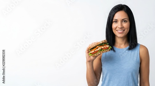 Smiling woman holding a healthy chicken sandwich for lunch isolated