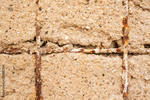 Cracked Concrete Wall with Rusty Rebar Texture Closeup