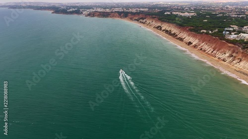 Aerial. Sandy coasts beaches filmed from the sky drone. fast boat speeding across the ocean