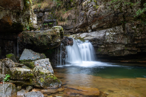 Fotografie Scenic landscape in deciduous forest and waterfall in Sierra Cebollera in La Rio