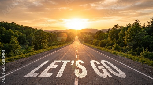Inspirational road with lets go text leading towards a bright sunset