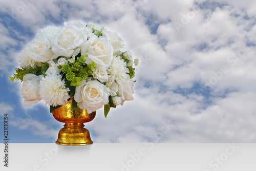 front view white roses and white flower and green leaves on golden phan on white cloud and blue sky background, fruit, food, fresh, object, health, copy space