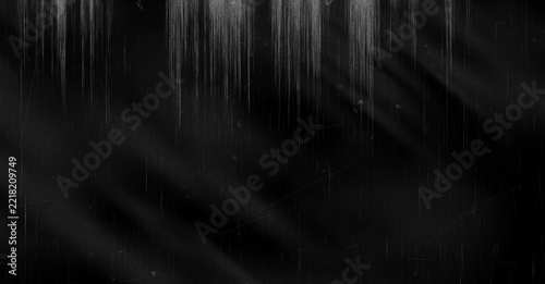 Abstract dark grunge background with vertical light streaks and textured grain