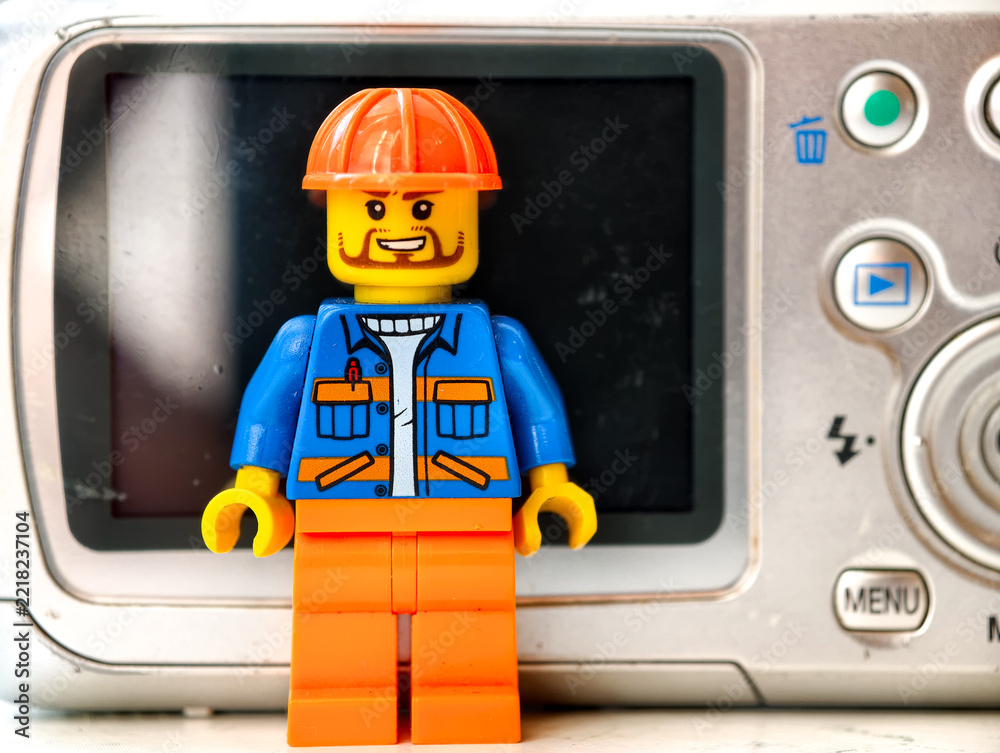 Naklejka premium Russia, St. Petersburg, August 8, 2020 A lego man standing in front of a camera, ready to capture the moment