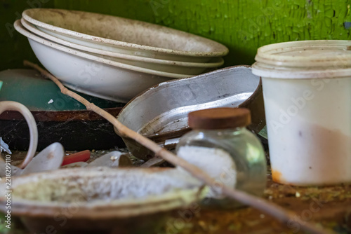 Dirty old dishes on a table in an abandoned house