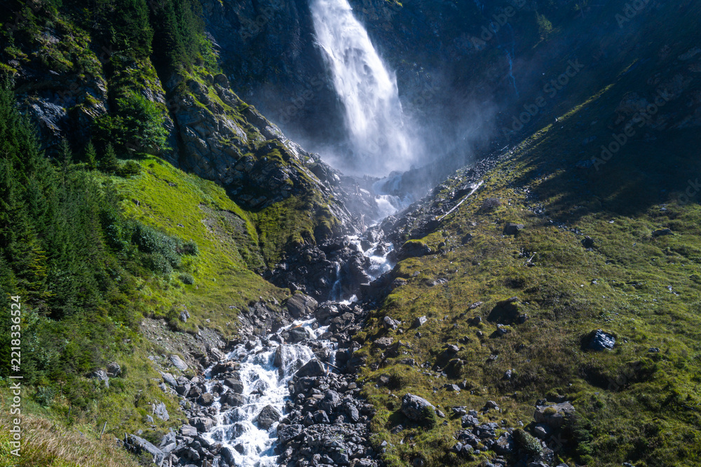 Fototapeta premium Waterfall called Staubenfall in Canton Uri. Waterfall known as Staubifall in Switzerland. Swiss Alps surround waterfall near Uri. Uri mountain landscape frames waterfall naturally.