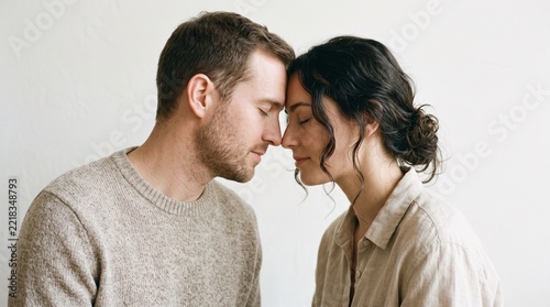 Young couple touching foreheads in a tender and intimate romantic moment with loving couple forehead to forehead emotional connection young lovers