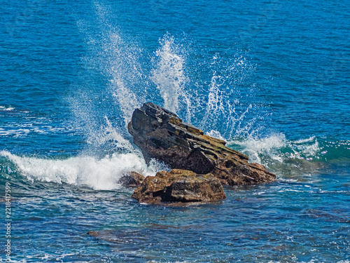 Ocean waves crashing against jagged rocks in Xuhai, Pingtung, Taiwan. 