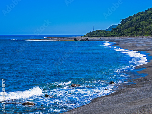 Sunny coastline with blue sea and green hills in Xuhai, Pingtung, Taiwan.  
