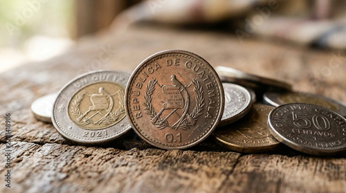 Guatemalan Quetzal Coins on Rustic Wooden Table Macro Shot of Currency and Money
