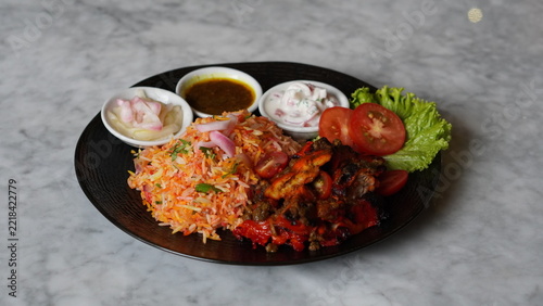 Fotografie Spicy red fried rice with delicious side dishes