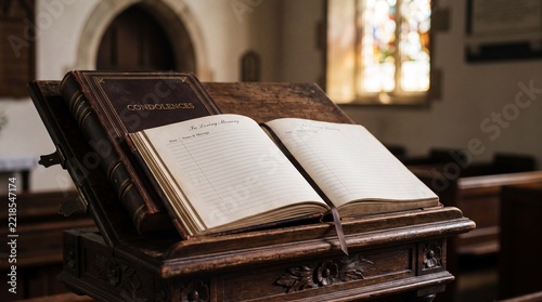 Ancient open book resting on a wooden lectern in a historic library setting.