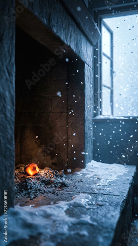 Cozy but cold fireplace with a single smoldering coal in a snowy winter scene with snowflakes falling through an open window, copy space