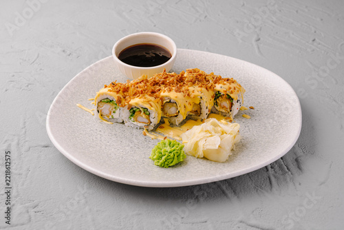 Uramaki sushi rolls with tempura shrimp and sauce