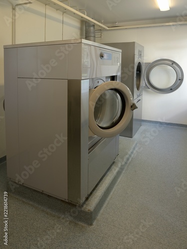 Shared apartment building laundry room with washing machine