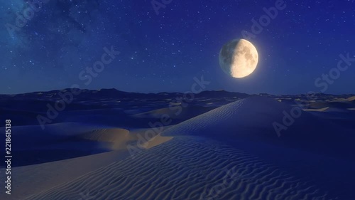 Crescent moon rising over desert dunes under a starry night sky