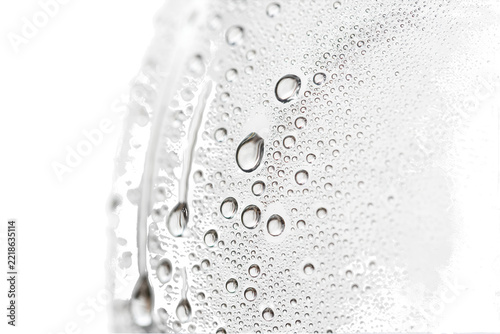 Extreme macro close-up of condensation droplets on a curved glass surface with reflected light and dark tones