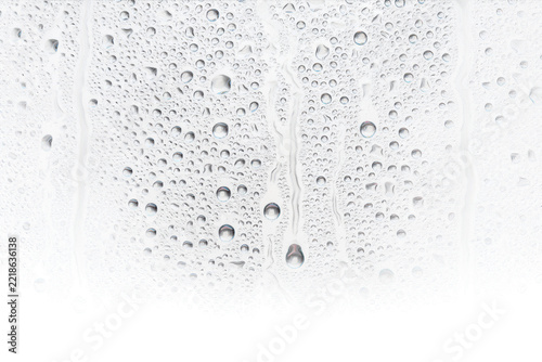Macro of condensation droplets and water streaks on a clear glass surface with a gradient texture