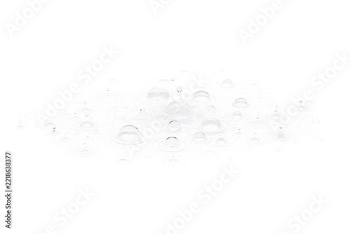 Top-down macro view of concentric water ripples and splashing droplets forming a complex pattern of circular waves on a liquid surface