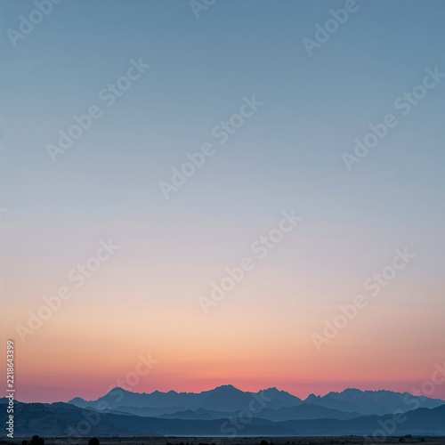 Serene mountain range at sunrise with soft pastel sky for travel inspiration