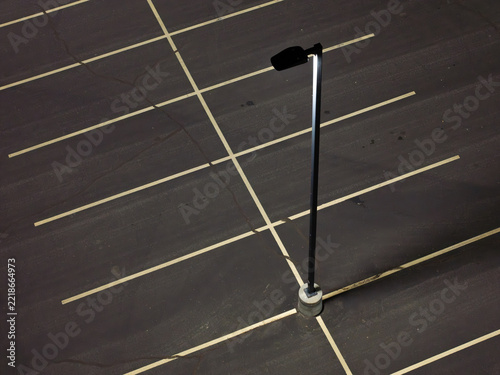 Dark asphalt parking lot with crisp white lines