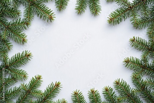 Natural frame made of fresh green pine branches on a white background for Christmas and New Year
