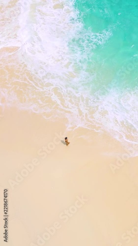 Woman Standing on Sandy Shore with Turquoise Waves Top View