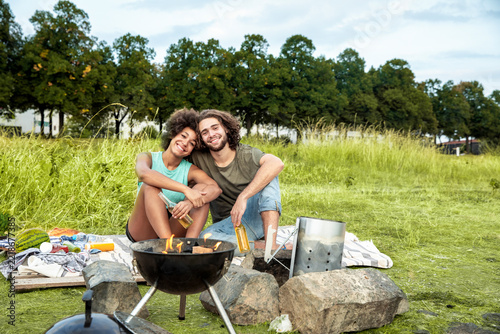 Happy couple having a barbecue in the nature
