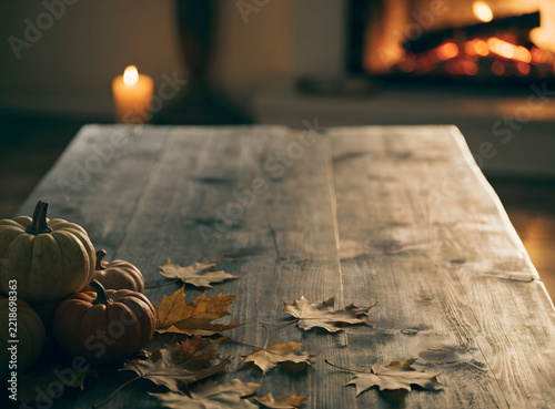 Rustic Thanksgiving table background realistic photo with warm candlelight, pumpkins and autumn leaves, vertical composition

