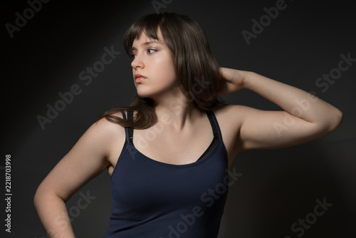 Beautiful teenage girl posing for beauty concept on dark background