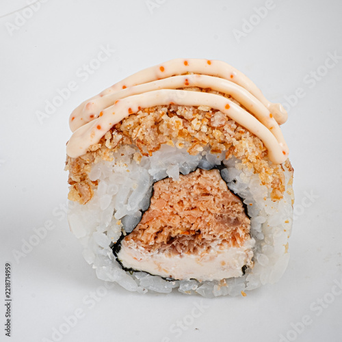 Savoring a delicious sushi roll with creamy toppings and crispy texture inside